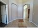 Neutral-toned foyer with tile floor, decorative rug accents and arched doorways into other rooms at 2932 Trema Ave, Winter Haven, FL 33881