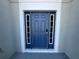 A vibrant blue front door flanked by sidelights adds curb appeal to this home at 2932 Trema Ave, Winter Haven, FL 33881