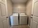 Laundry room with appliances and overhead storage, conveniently located near doorways at 2932 Trema Ave, Winter Haven, FL 33881