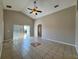 This bright living room features tile floors, sliding glass doors, and a ceiling fan at 2932 Trema Ave, Winter Haven, FL 33881