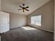 Spacious main bedroom with ceiling fan, carpet, and natural light from the windows at 2932 Trema Ave, Winter Haven, FL 33881