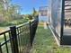 Backyard with a black fence along a canal and screened patio area, partially shaded by trees at 322 N Shadowbay Blvd, Longwood, FL 32779