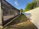 A backyard is defined by a vinyl fence and the adjacent screened-in lanai at 322 N Shadowbay Blvd, Longwood, FL 32779