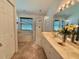 Bright bathroom featuring a double vanity, tile flooring, and decorative floral arrangements at 322 N Shadowbay Blvd, Longwood, FL 32779