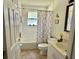 Cozy bathroom featuring a shower-tub combo, patterned shower curtain, and neutral color palette at 322 N Shadowbay Blvd, Longwood, FL 32779