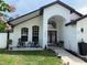 Charming home exterior with rocking chairs on the front porch and a well-manicured lawn at 322 N Shadowbay Blvd, Longwood, FL 32779