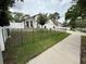 A lovely home with a black metal fence, a well-manicured lawn, and mature trees at 322 N Shadowbay Blvd, Longwood, FL 32779