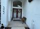 Inviting entryway featuring a decorative wreath on the front door, and a comfortable bench at 322 N Shadowbay Blvd, Longwood, FL 32779