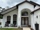 Inviting front entrance featuring a double-door entry, rocking chairs, and a well-kept lawn at 322 N Shadowbay Blvd, Longwood, FL 32779