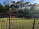 Iron fence borders a greenbelt and pond, adding beauty to this property at 322 N Shadowbay Blvd, Longwood, FL 32779