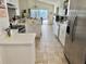 Well-lit kitchen featuring stainless steel appliances, white cabinets, ample counter space, and modern fixtures at 322 N Shadowbay Blvd, Longwood, FL 32779