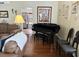 Cozy living area with a piano, leather seating, and natural light, perfect for entertaining and relaxation at 322 N Shadowbay Blvd, Longwood, FL 32779