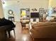 Open-concept living area with comfortable leather seating, a large TV, and stylish decor, ideal for Gathering gatherings at 322 N Shadowbay Blvd, Longwood, FL 32779
