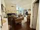 Open-concept living room featuring a piano, leather seating, and hardwood flooring at 322 N Shadowbay Blvd, Longwood, FL 32779