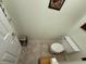 Compact powder room featuring neutral tile flooring, white walls, and a toilet at 322 N Shadowbay Blvd, Longwood, FL 32779