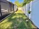 A view of a side yard with a white fence, hammock and green grass at 322 N Shadowbay Blvd, Longwood, FL 32779