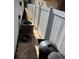 Narrow side yard featuring privacy fence, A/C unit, and trash containers at 322 N Shadowbay Blvd, Longwood, FL 32779