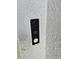 Modern black and white smart doorbell, with camera, on a textured wall at 3223 Evenmore Way, Wildwood, FL 34785