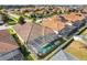 Aerial view of a backyard, screened in pool, and tile roof at 323 Villa Sorrento Cir, Haines City, FL 33844