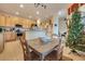 Bright kitchen with wooden cabinets, stainless appliances and adjacent dining area with a vintage farmhouse table at 323 Villa Sorrento Cir, Haines City, FL 33844