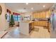 Bright kitchen with wooden cabinets, an island counter and adjacent dining area with a vintage farmhouse table at 323 Villa Sorrento Cir, Haines City, FL 33844