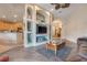 Inviting living room featuring a decorative built-in, wood floors, and a view towards the kitchen and entry at 323 Villa Sorrento Cir, Haines City, FL 33844