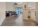 Open-concept living room with modern flooring, a ceiling fan, and sliding glass doors to the outdoor patio at 323 Villa Sorrento Cir, Haines City, FL 33844