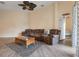 Cozy living room featuring wood-look flooring, a comfortable sofa, and easy access to other rooms in the house at 323 Villa Sorrento Cir, Haines City, FL 33844