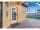 Screened pool door leading to a covered lanai and private backyard oasis at 323 Villa Sorrento Cir, Haines City, FL 33844