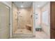 Bathroom featuring tiled walk-in shower with shower head and a small bench at 3262 Amaca Cir, Orlando, FL 32837