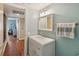 Bathroom with decorative sink vanity, mirror, and a view to another living space at 3262 Amaca Cir, Orlando, FL 32837