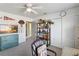 Bedroom featuring a ceiling fan, dresser, and a view to another living space at 3262 Amaca Cir, Orlando, FL 32837