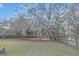 Expansive backyard with mature trees and a wooden fence at 328 Bridle Path, Casselberry, FL 32707