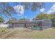 Overview of the home's backyard featuring a screened-in pool and patio area at 328 Bridle Path, Casselberry, FL 32707