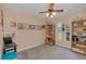 Pink bedroom featuring built-in wooden shelves, a ceiling fan, and carpeted flooring at 328 Bridle Path, Casselberry, FL 32707