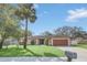 Well-maintained single-story home with lush green lawn and mature landscaping at 328 Bridle Path, Casselberry, FL 32707