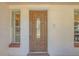 Close-up of an attractive front door with decorative glass and sidelight windows at 328 Bridle Path, Casselberry, FL 32707