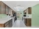 Well-lit kitchen with rustic wood cabinets, white countertops, and modern appliances at 328 Bridle Path, Casselberry, FL 32707