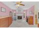 Comfortable living room features a white fireplace and natural light, perfect for relaxation at 328 Bridle Path, Casselberry, FL 32707