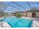 A beautiful screened in backyard pool with a covered patio and lounge chairs at 328 Bridle Path, Casselberry, FL 32707