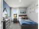 Serene bedroom with soft blue walls, neutral grey dresser, and carpet creating a relaxing and calm space at 3623 Marlbrry Way, Sanford, FL 32773