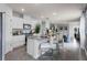 Modern open-concept kitchen with white cabinets, stainless steel appliances, and a granite-topped island with seating at 3623 Marlbrry Way, Sanford, FL 32773