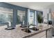 Close-up of modern kitchen with stainless steel sink, granite counters, and eat-in island with modern decor at 3623 Marlbrry Way, Sanford, FL 32773