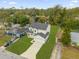 Aerial view of a two-story home with a big lawn and an attached two-car garage on a partly cloudy day at 3778 Martin St, Orlando, FL 32806