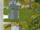 Birds-eye view of home with fenced-in yard, featuring green grass and a long driveway leading up to the garage at 3778 Martin St, Orlando, FL 32806