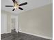 Bedroom features wood-look flooring, a ceiling fan, and fresh paint at 3778 Martin St, Orlando, FL 32806