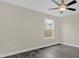 This bedroom includes dark wood-look flooring, neutral paint, and a well-lit window at 3778 Martin St, Orlando, FL 32806