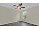 Light-filled bedroom with dark wood-look flooring, neutral paint, and a bright window at 3778 Martin St, Orlando, FL 32806