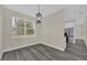 Dining area featuring modern light fixture and stainless steel refrigerator at 3778 Martin St, Orlando, FL 32806