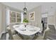 Bright dining room features a marble table, modern chandelier, and large window offering natural light at 3778 Martin St, Orlando, FL 32806